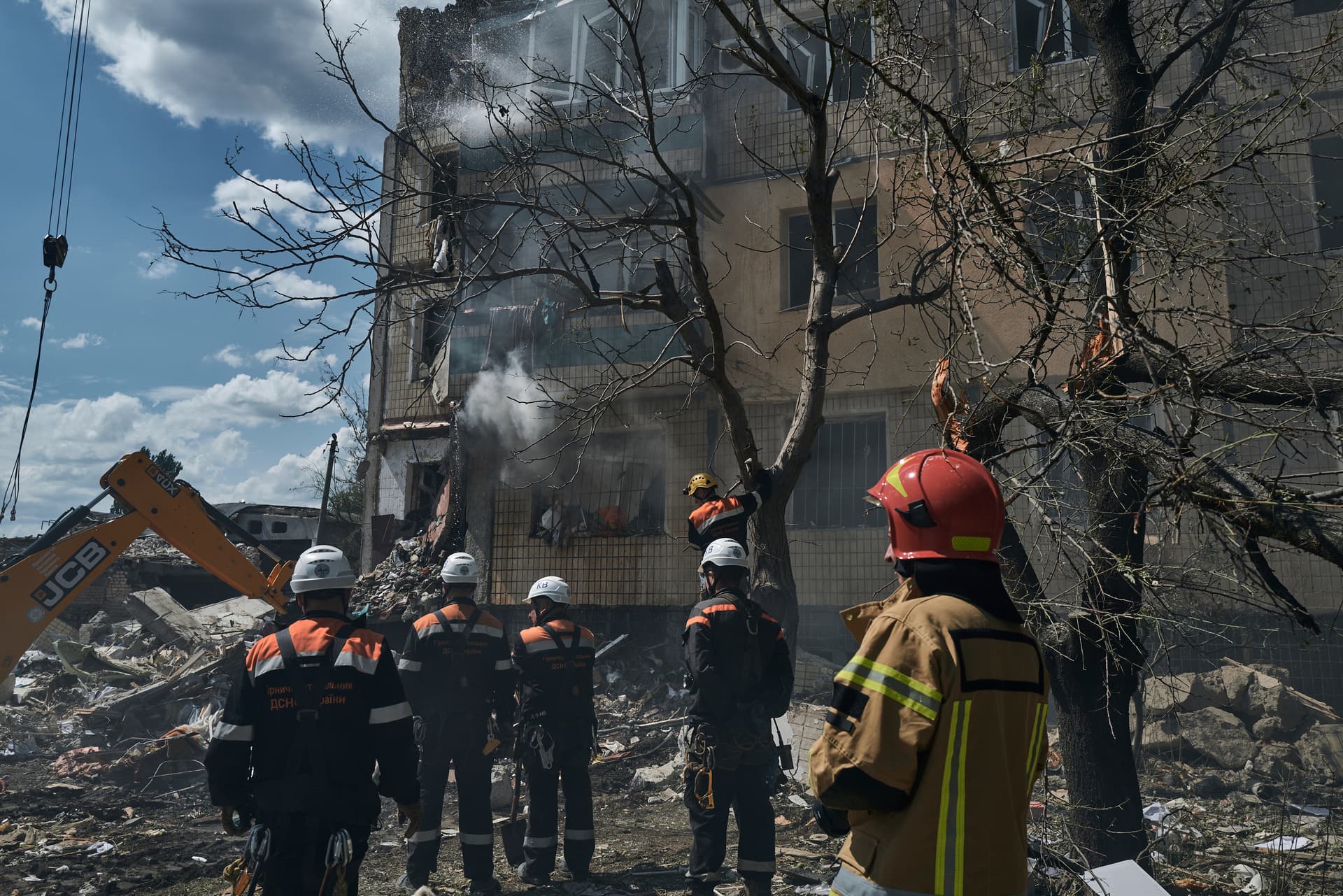 Emergency personnel work at the scene after a missile hit an apartment building in Kryvyi Rih