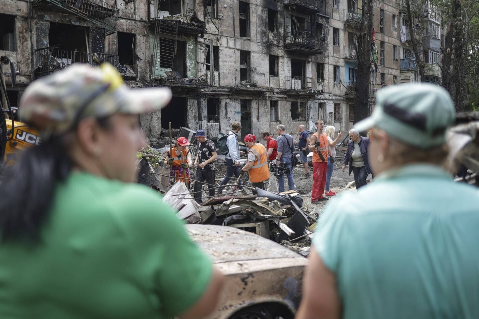 Municipal workers clean the site of the latest Russian rocket attack that damaged a multi-storey apartment building in Kryvyi Rih