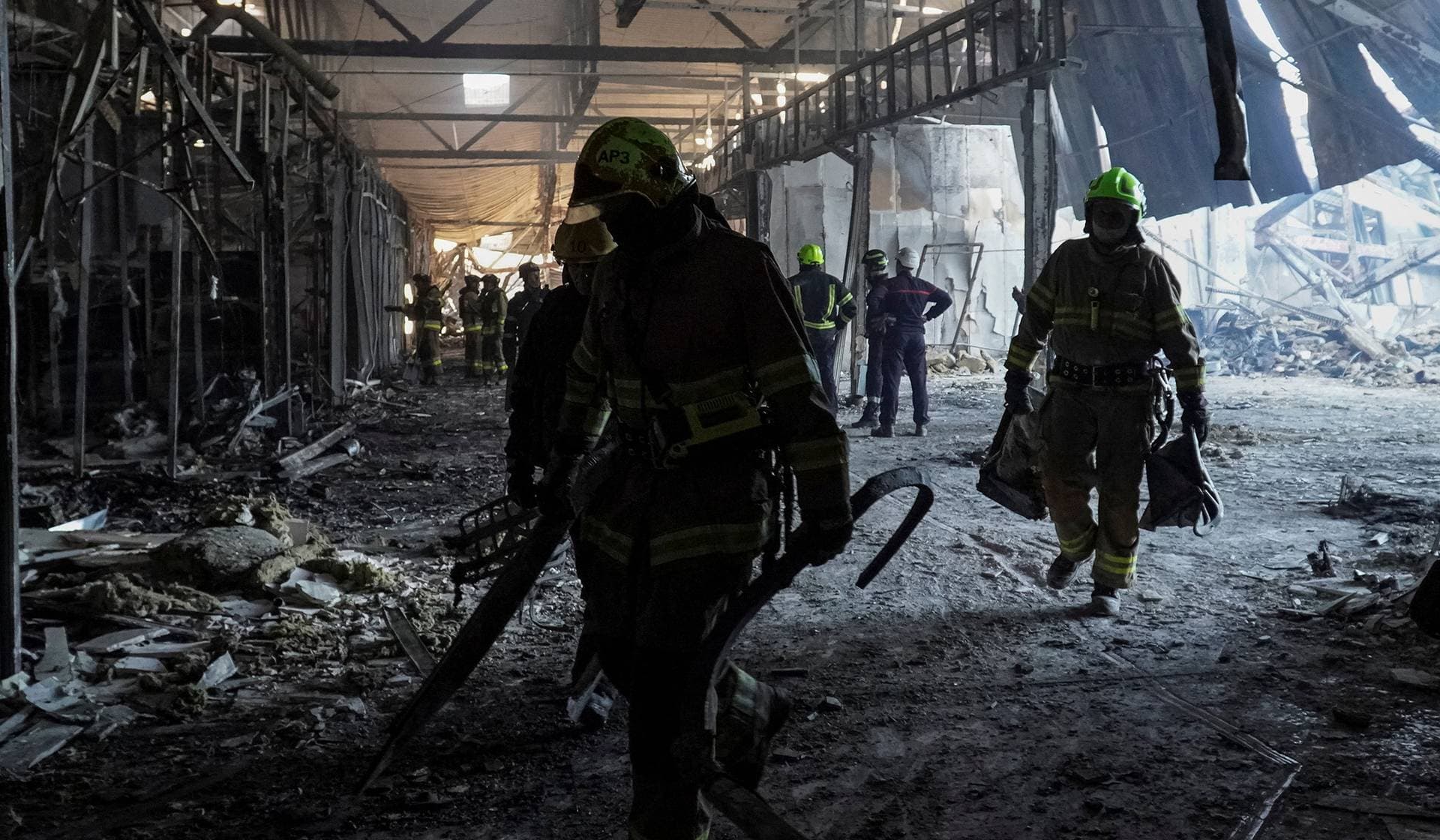 Rescuers work at the site of a shopping center destroyed by yesterday's Russian drone attack in Kryvyi Rih