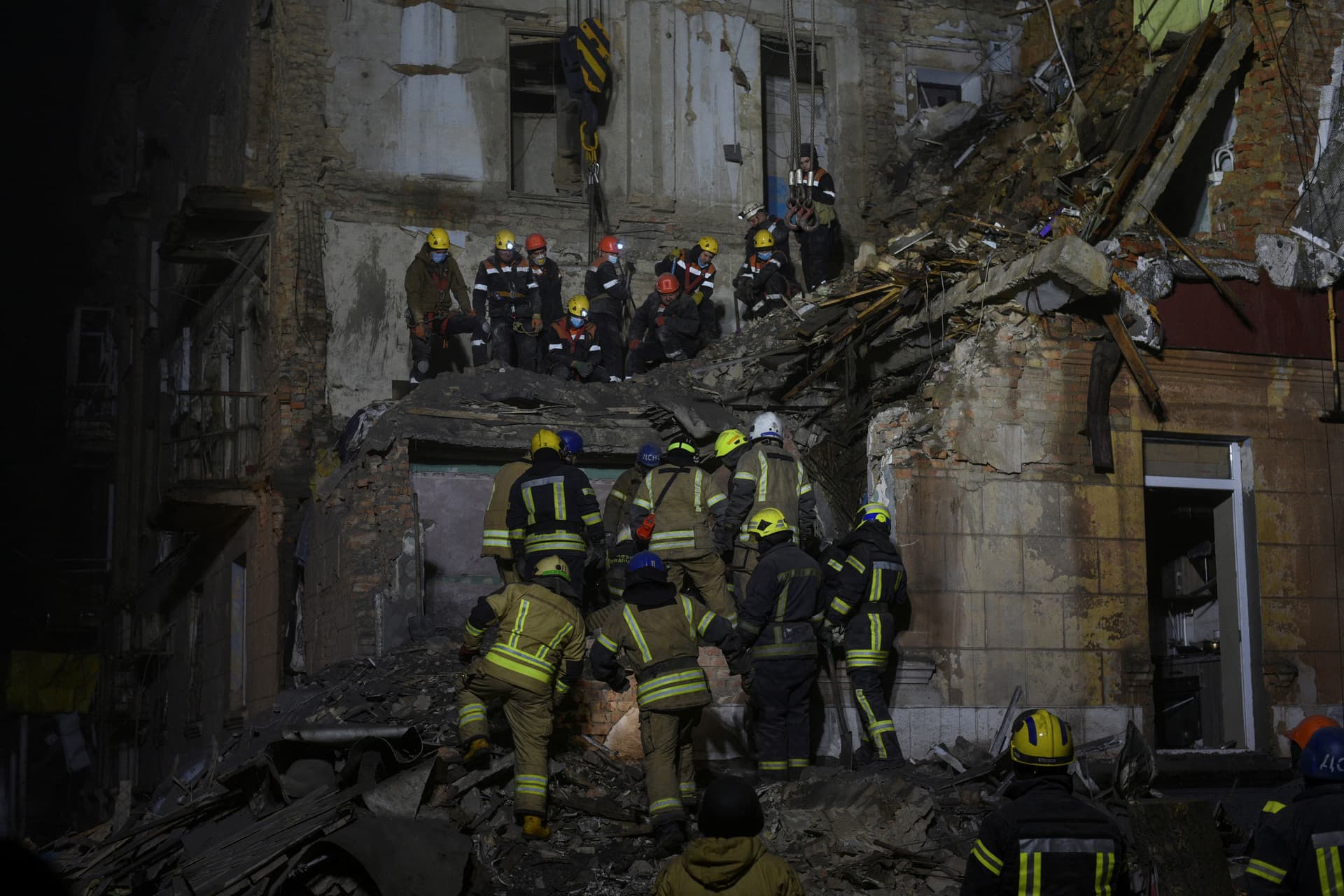 Rescuers work at the site of a residential building damaged by a Russian missile in Kryvyi Rih