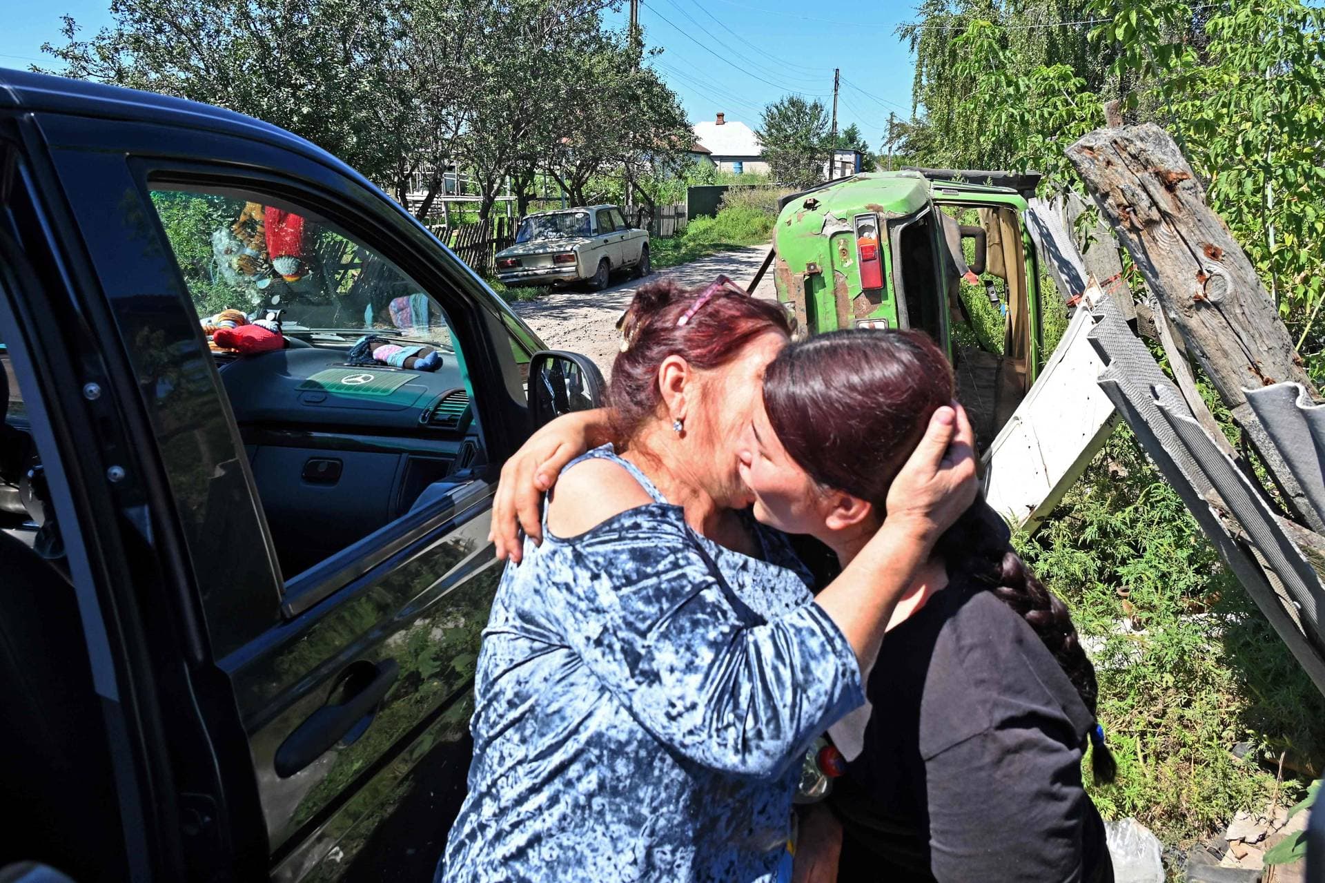 Lilia Bunescu says goodbye to her mother who evacuates from Kruglyakivka village
