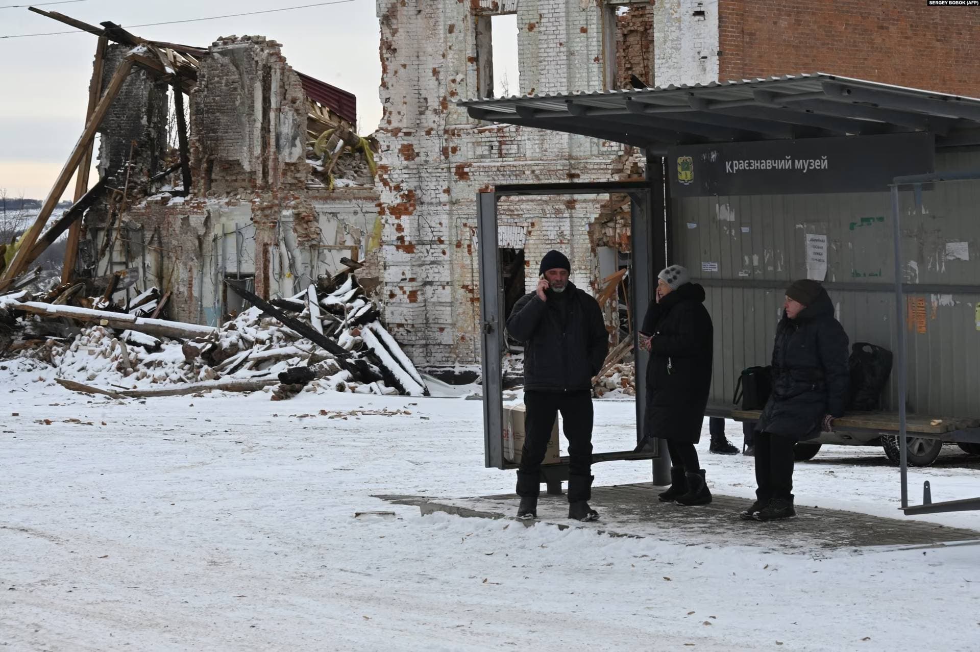 At a bus stop opposite the golden-domed Orthodox church, 62-year-old Halyna waited with two large shopping bags