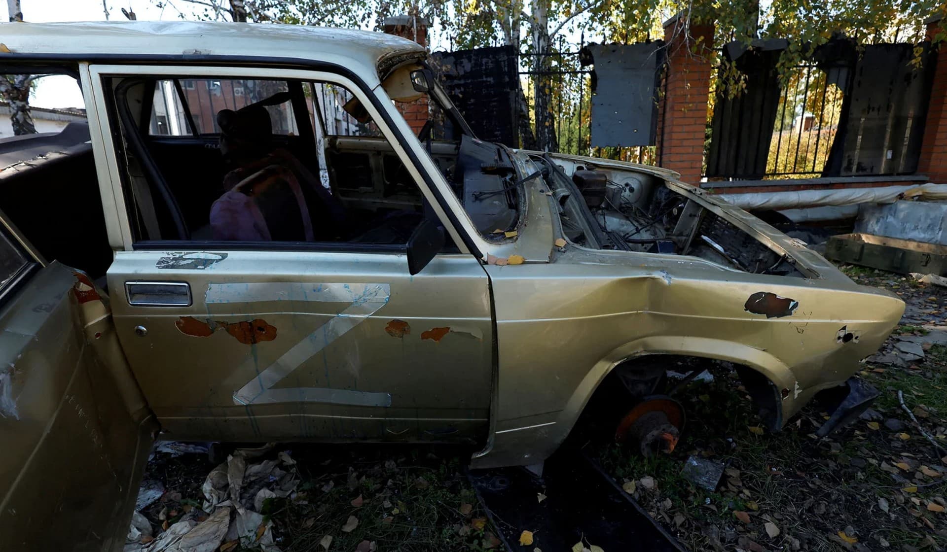 A damaged car with the letter Z among debris in the recently retaken town of Kupiansk