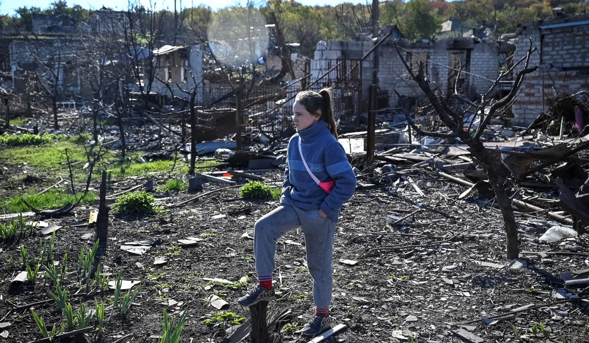 Local resident Ilona stands on ruins of her house in Kupiansk Vuzlovyi, Ukraine, October 17, 2022.