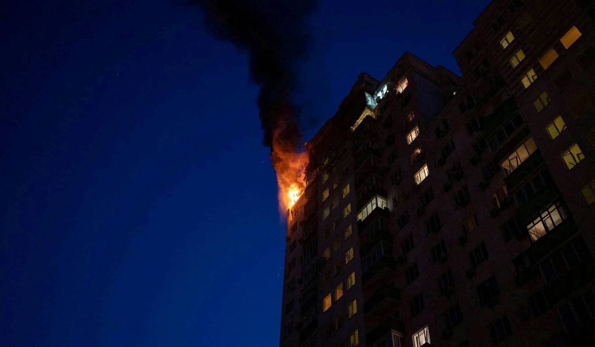 An apartment building burns after being damaged during a massive Russian drone strike in Kyiv