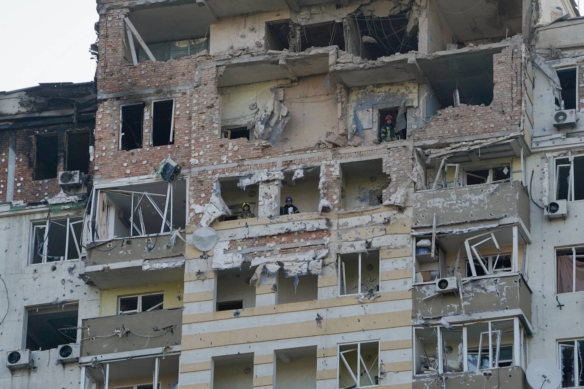 Rescue workers at an apartment building in Kyiv after it was damaged during a drone strike
