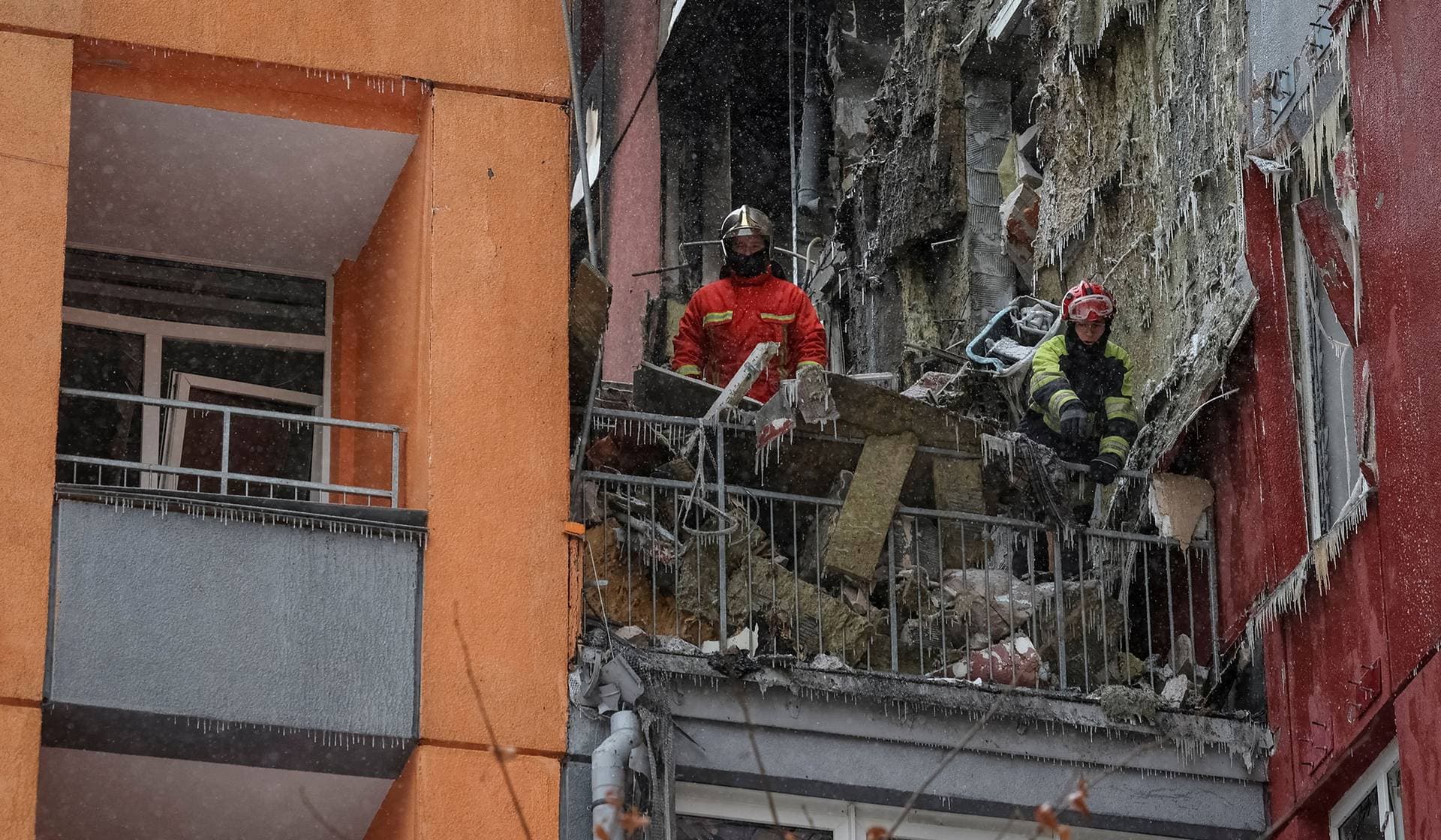 Rescuers work at the site of the apartment building hit by a Russian drone strike in Kyiv