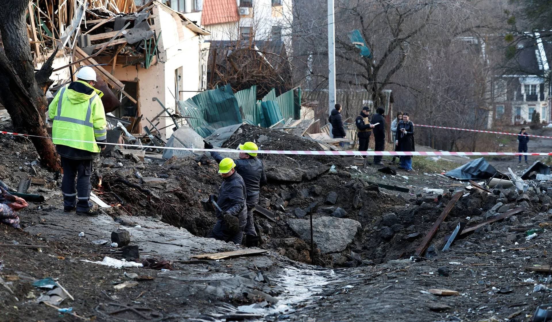People work at a site of a Russian missile strike in Kyiv