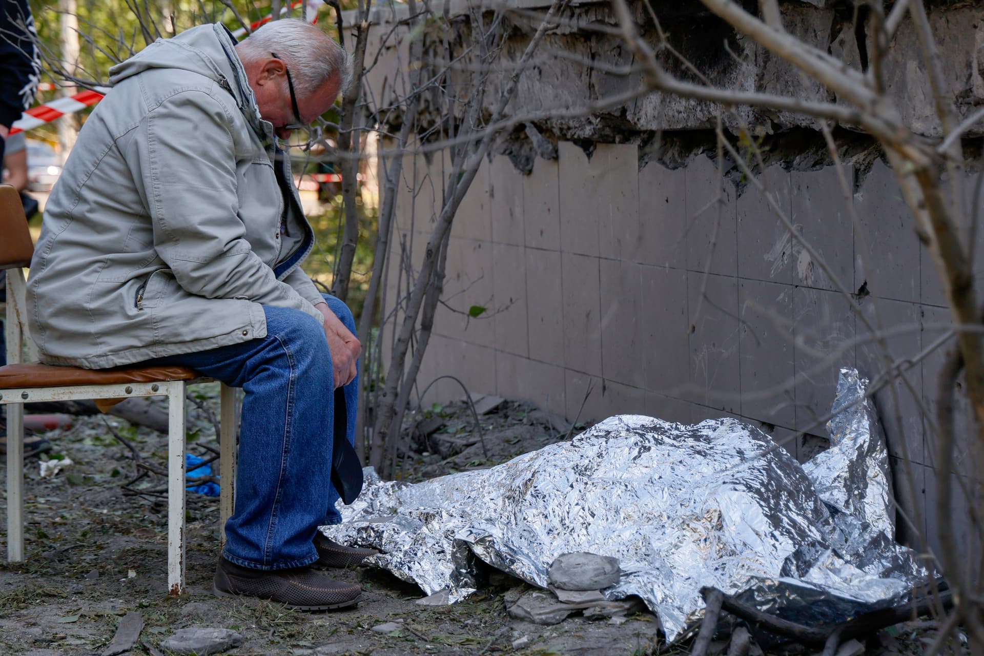 A relative mourns near a dead body after a Russian strike in Kyiv