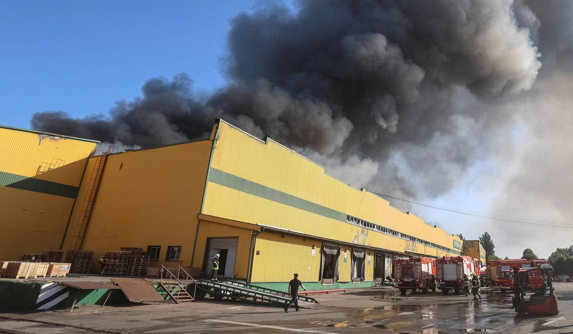 Firefighters work at a site of a Russian missile strike in the Kyiv Region