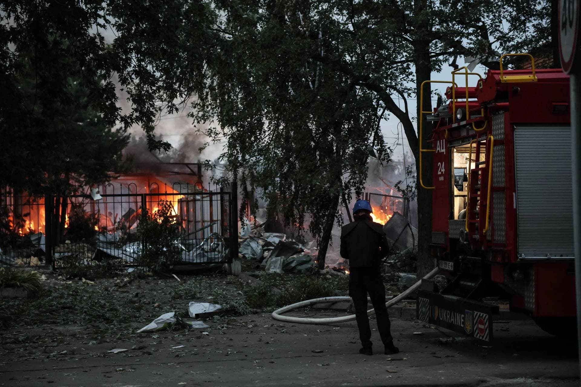 Ukrainian rescue service members work at the site of a missile strike on a residential area in Kyiv