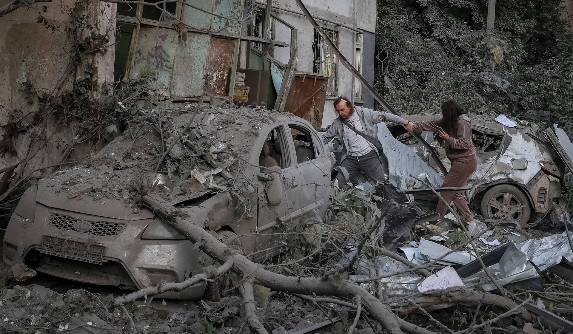 Residents near an apartment building damaged during a Russian drone and missile strike in Kyiv