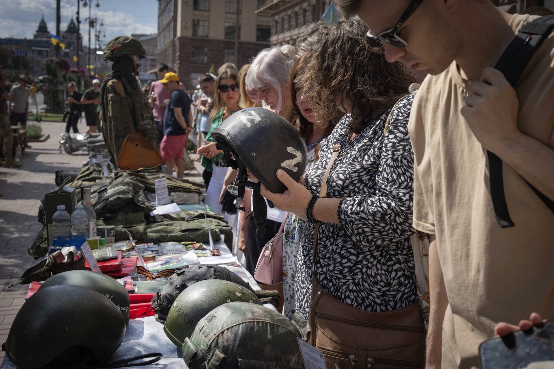 People look at equipment belonging to captured Russian soldiers on display on the central Khreshchatyk boulevard as Ukrainians mark Independence Day, in Kyiv