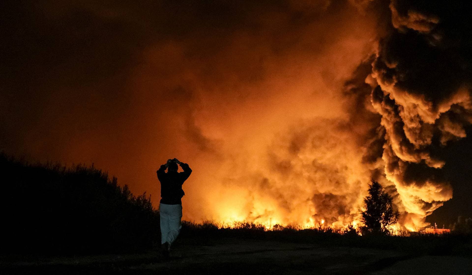 A resident looks at a site of a Russian missile strike in Kyiv Region