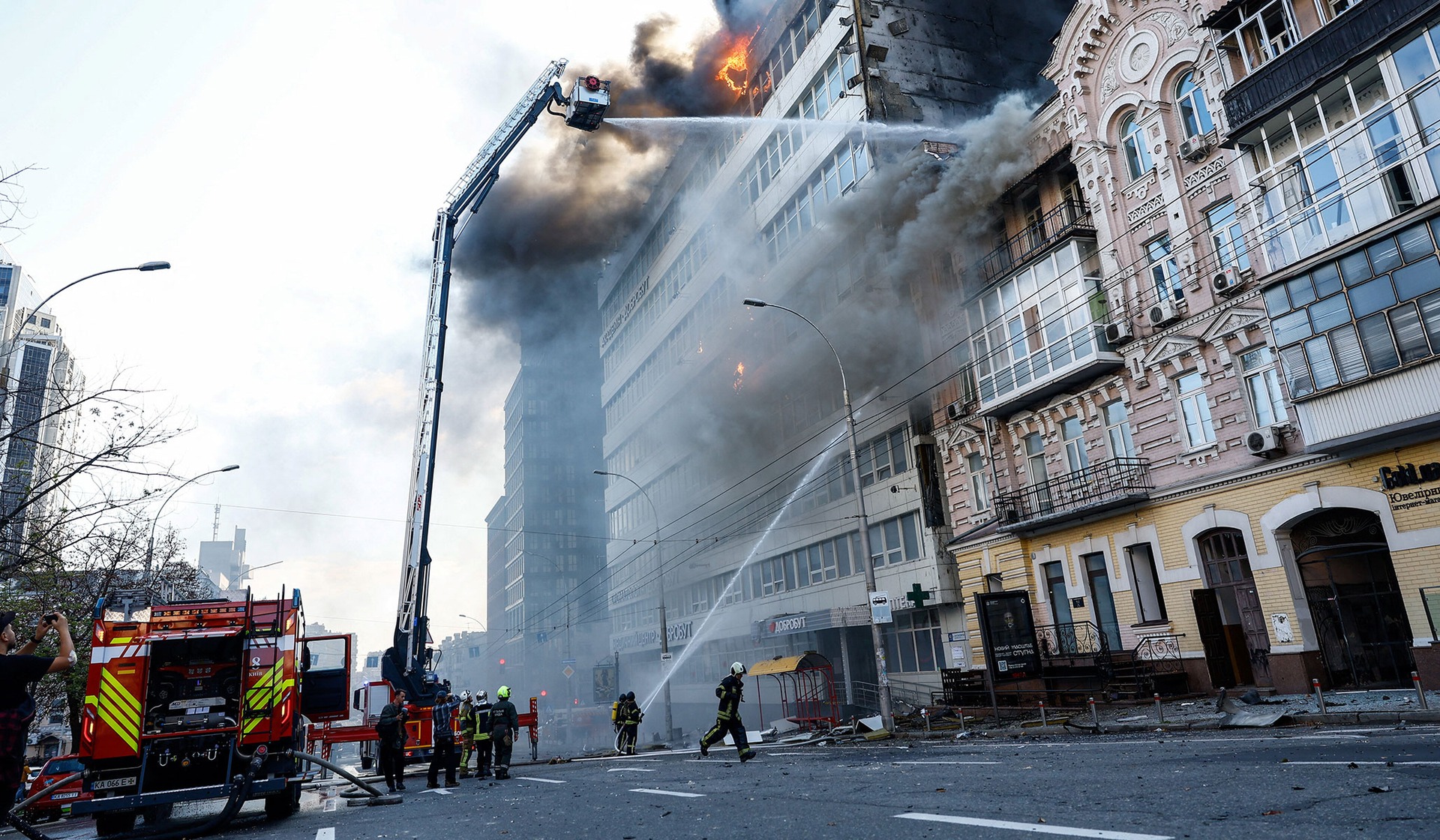 Firefighters work at the site of a Russian jet-powered drone strike in Kyiv