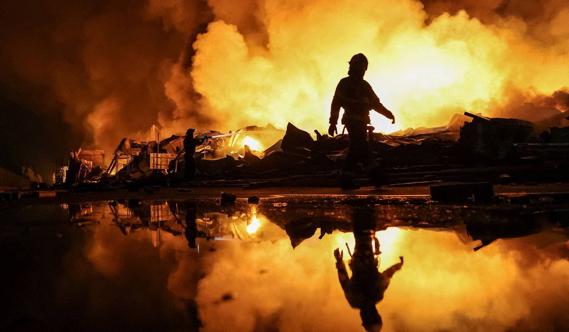 Firefighters work at a site of a Russian missile strike in Kyiv Region