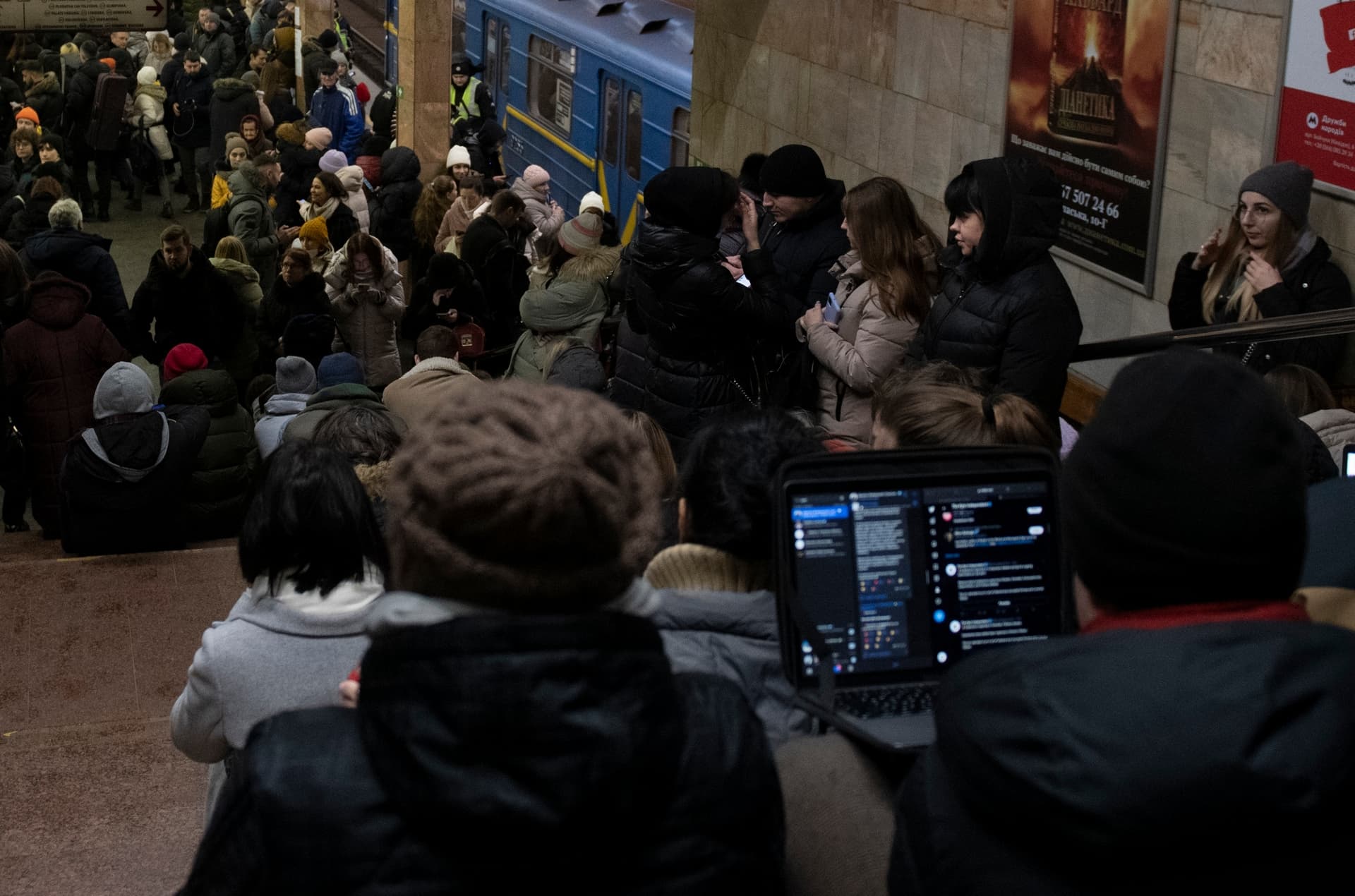 People rest in the subway station being used as a bomb shelter during a rocket attack in Kyiv