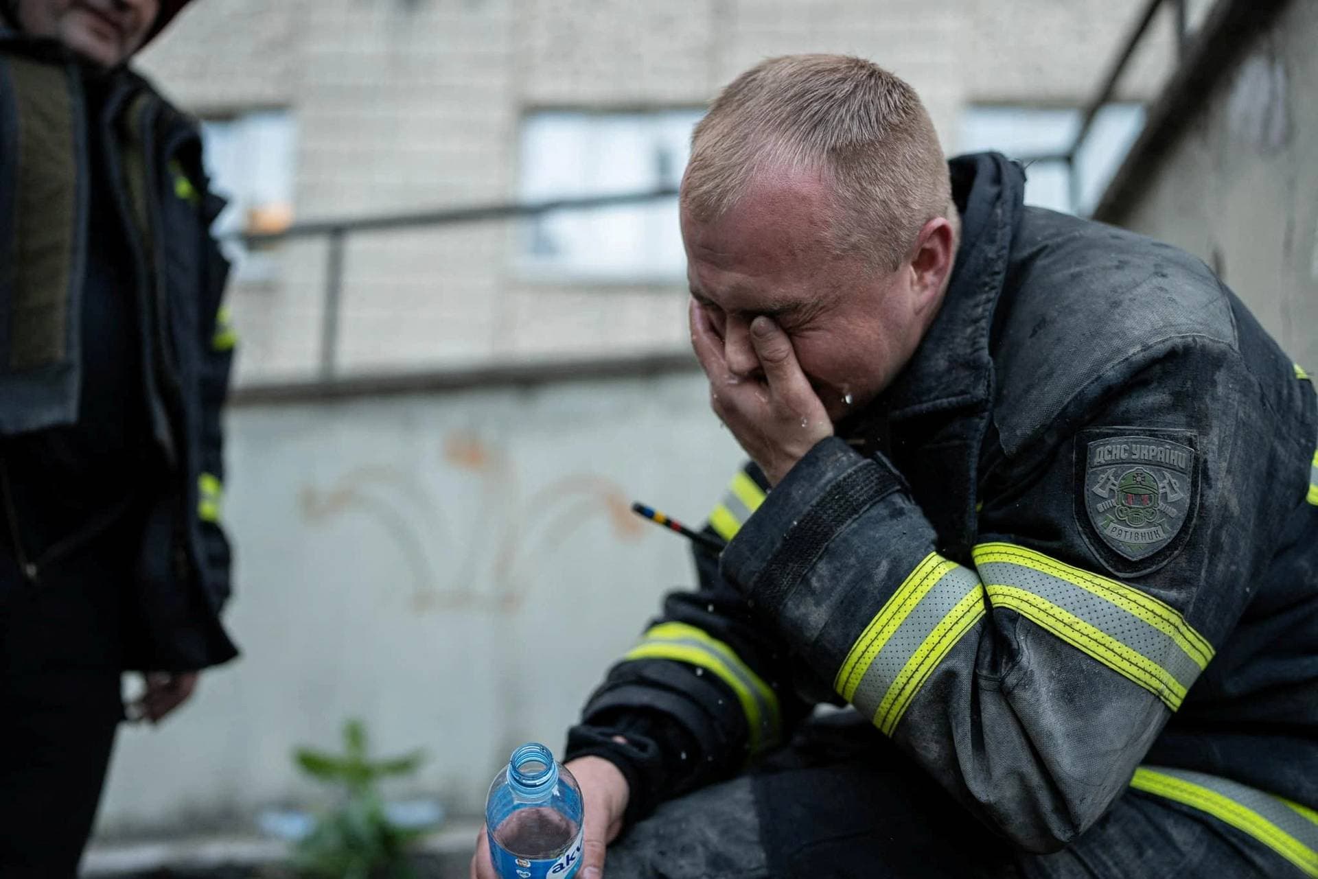 A rescuer reacts in front of an apartment building has been damaged during the Russian drone attack in Kyiv