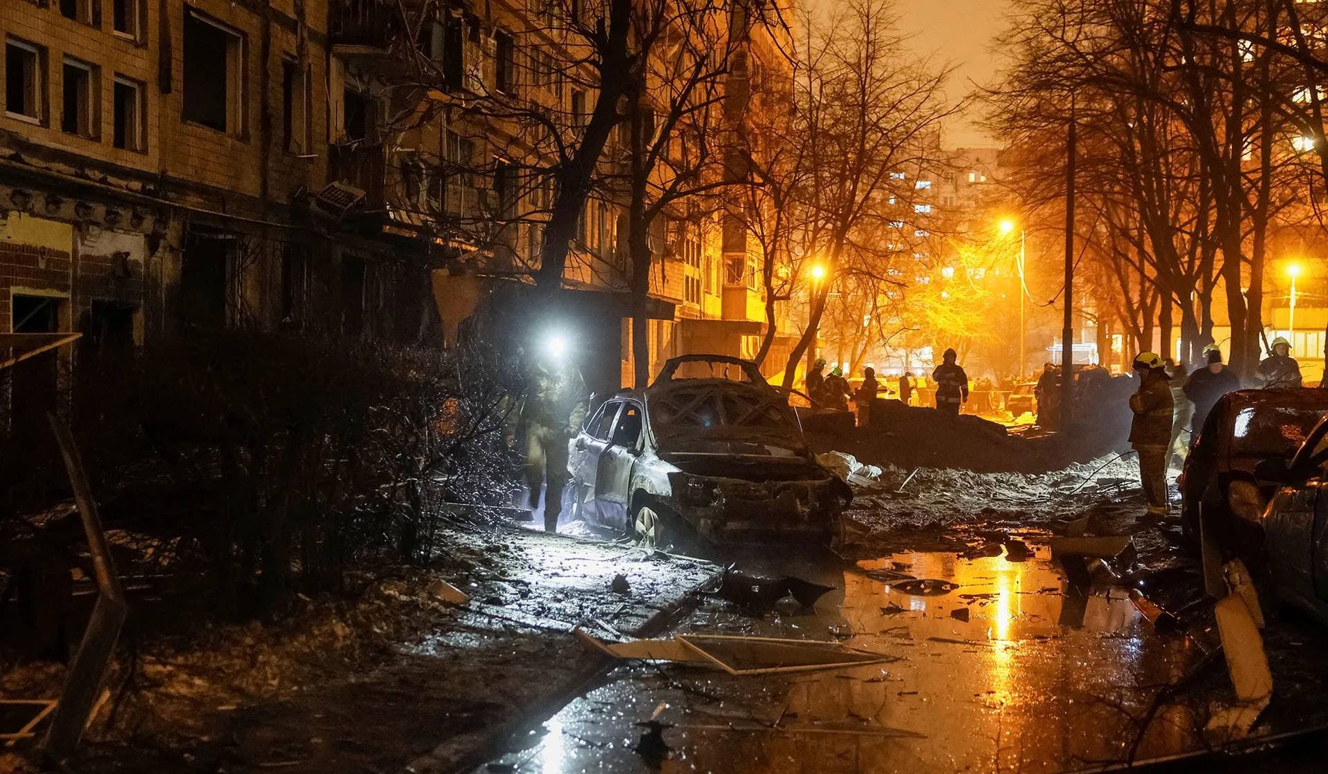 Emergency staff work at a site of an apartment building damaged during a Russian missile strike in Kyiv