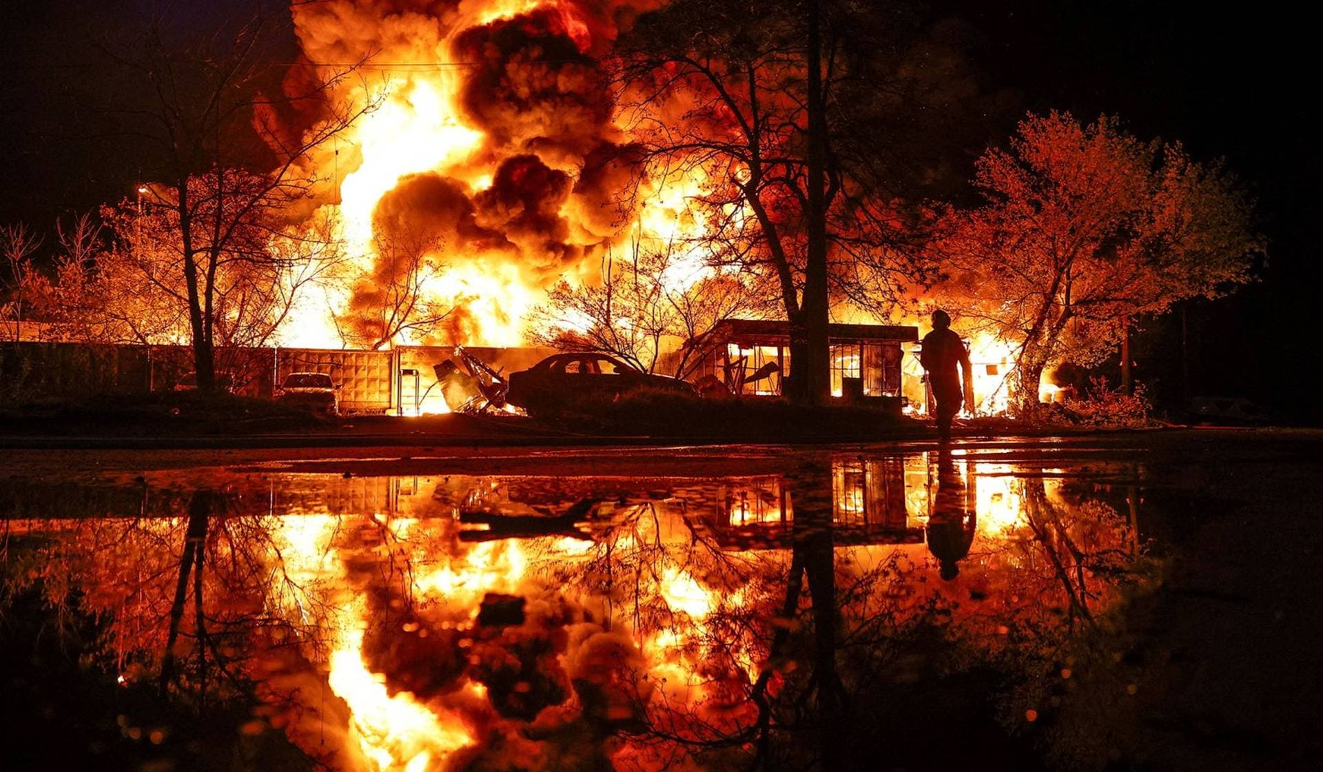A firefighter works at the site of a recyclable materials warehouse hit by a Russian missile strike in Kyiv