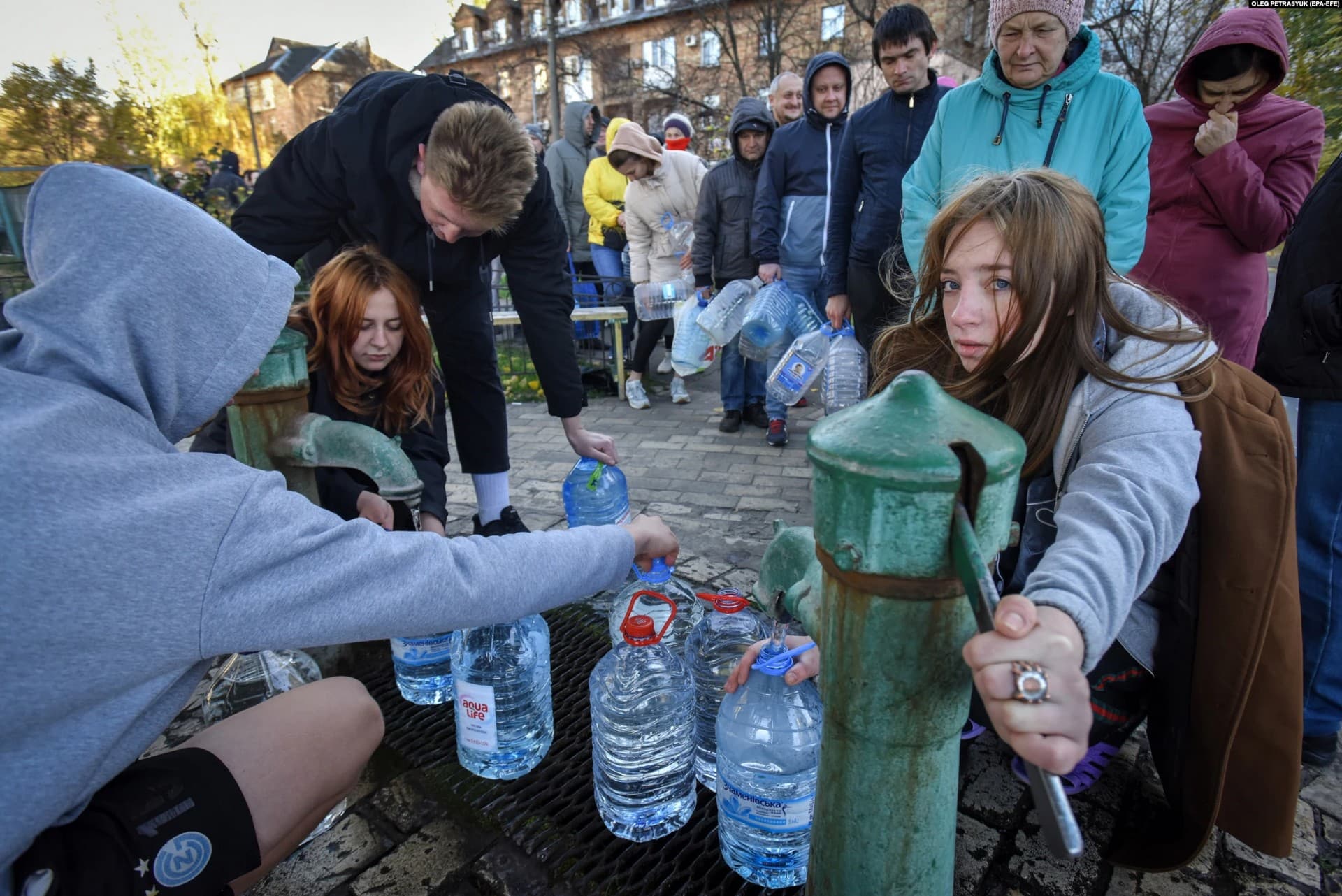People line up to get free water from a pump in Kyiv