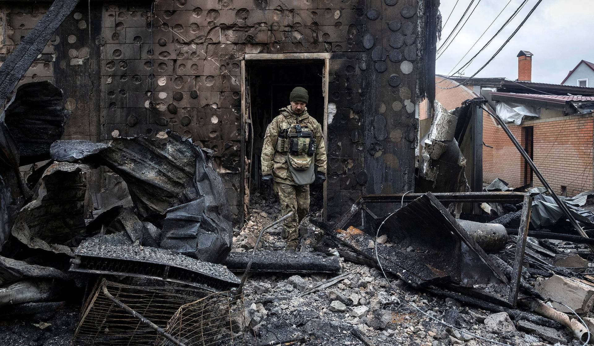 A police investigator leaves a residential building that was struck by a Russian drone during a night of Russian drone and missile attacks in Kyiv