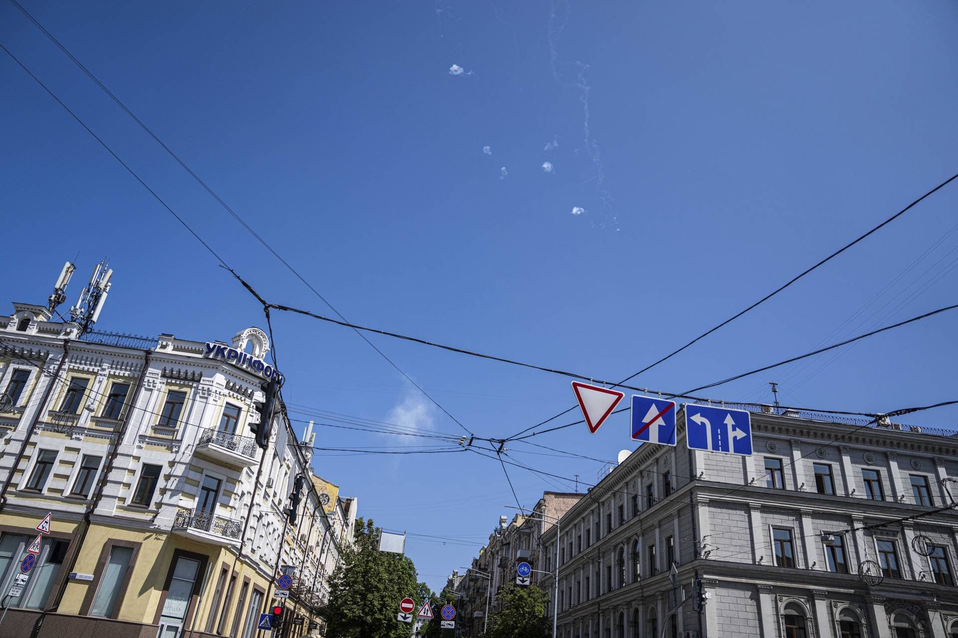 Tracks and white smoke are seen in the sky during Russian rocket attack in Kyiv