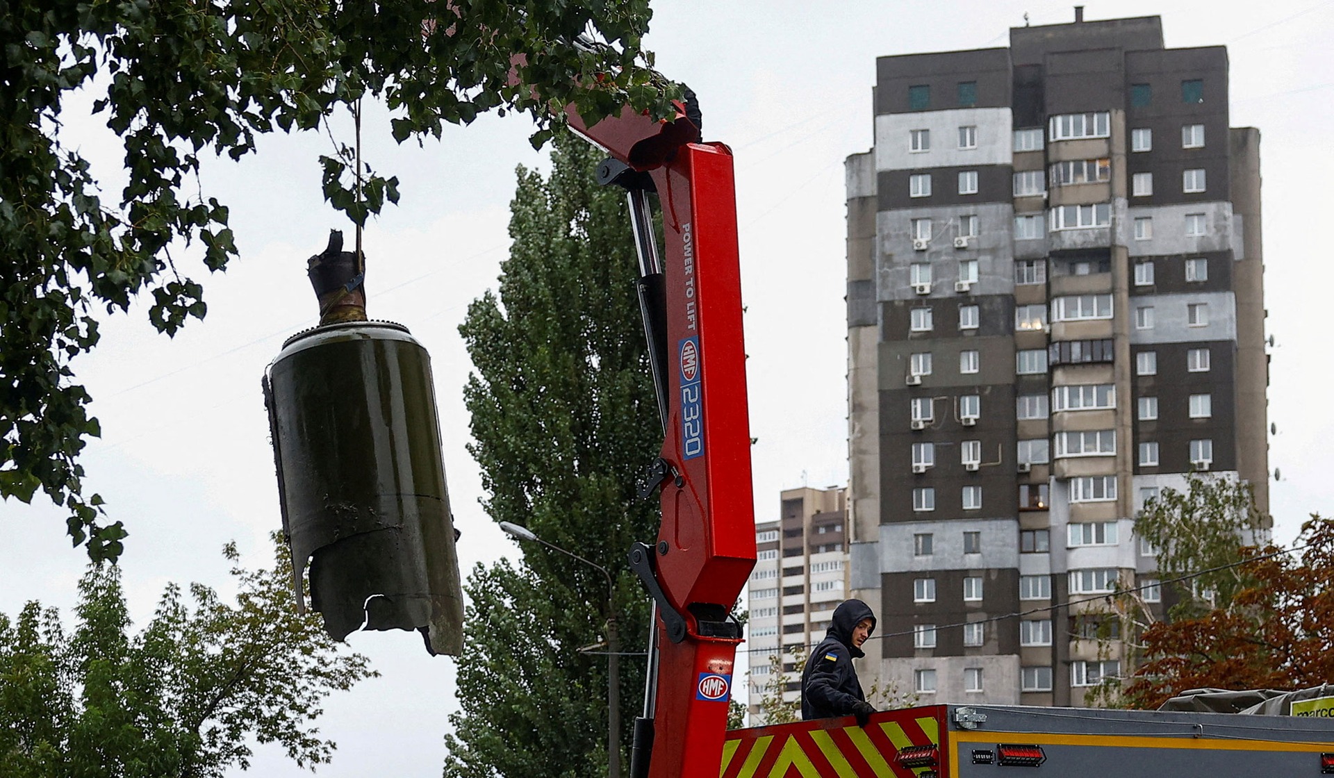 An emergency deminer loads a part of a Russian ballistic missile into a demining truck in Kyiv