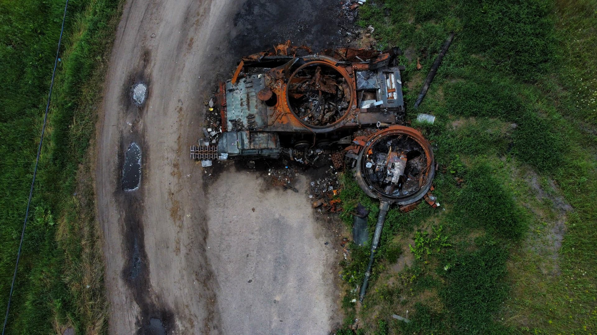 The gutted remains of a tank lie by a road in Lypivka, on the outskirts of Kyiv