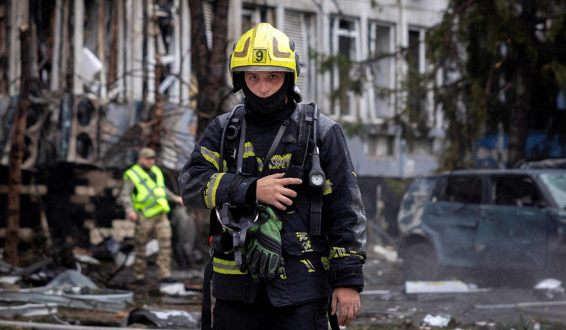 A firefighter works at the site of a business center that was struck by a Russian drone in Kyiv