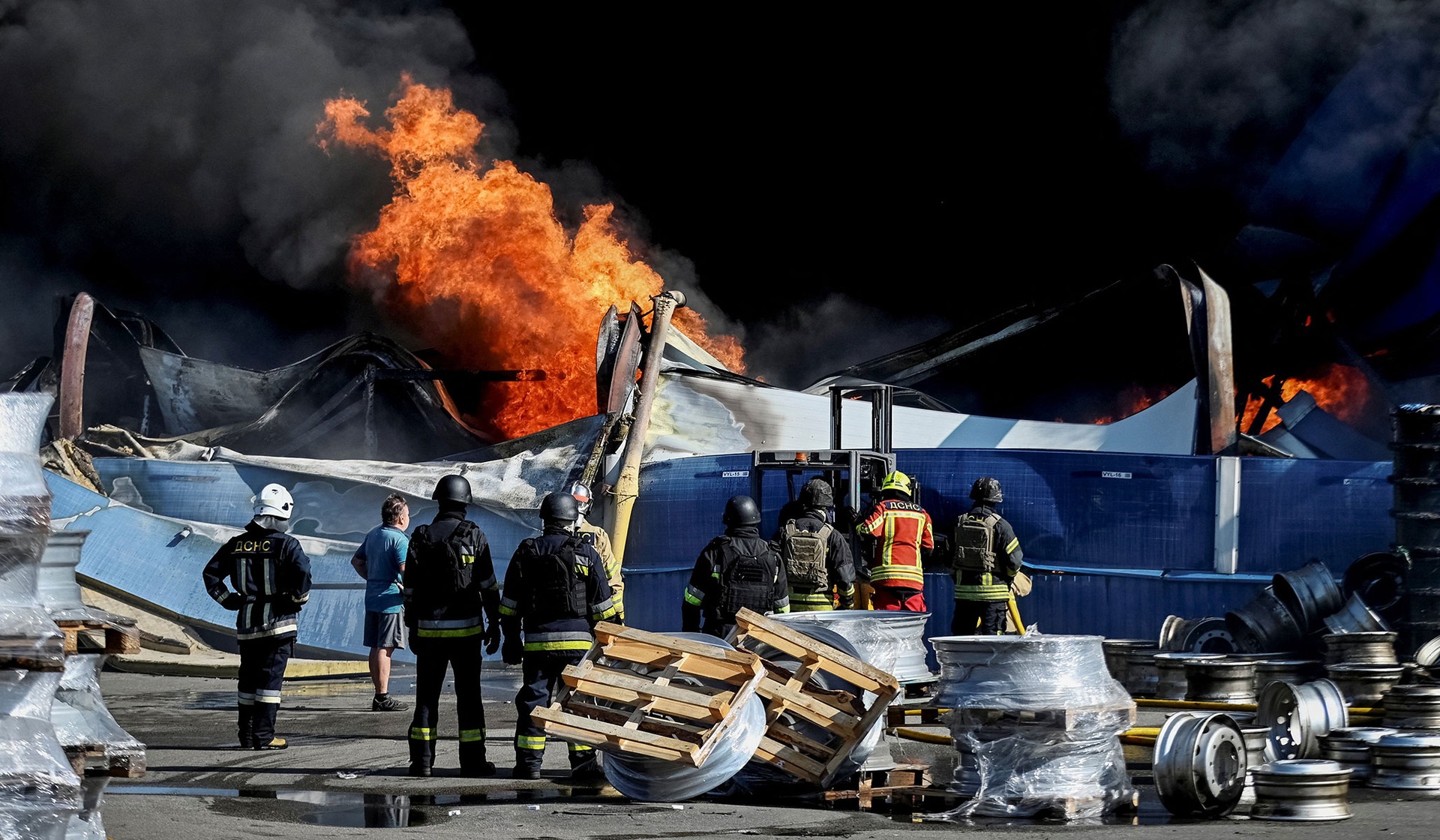 Firefighters work at the site of a Russian drone strike in Kyiv