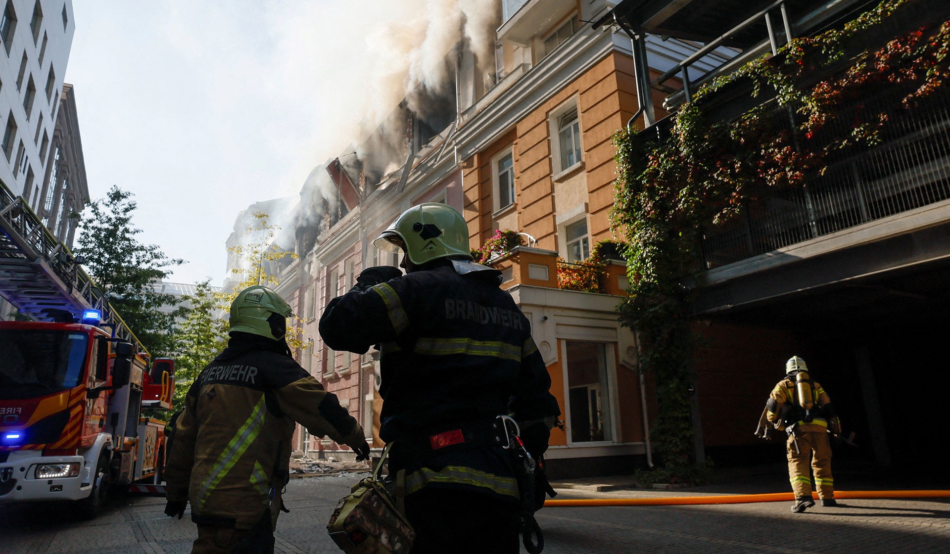 Firefighters work at the site of a business center hit by a Russian drone strike in Kyiv, Ukraine, September 23, 2026.