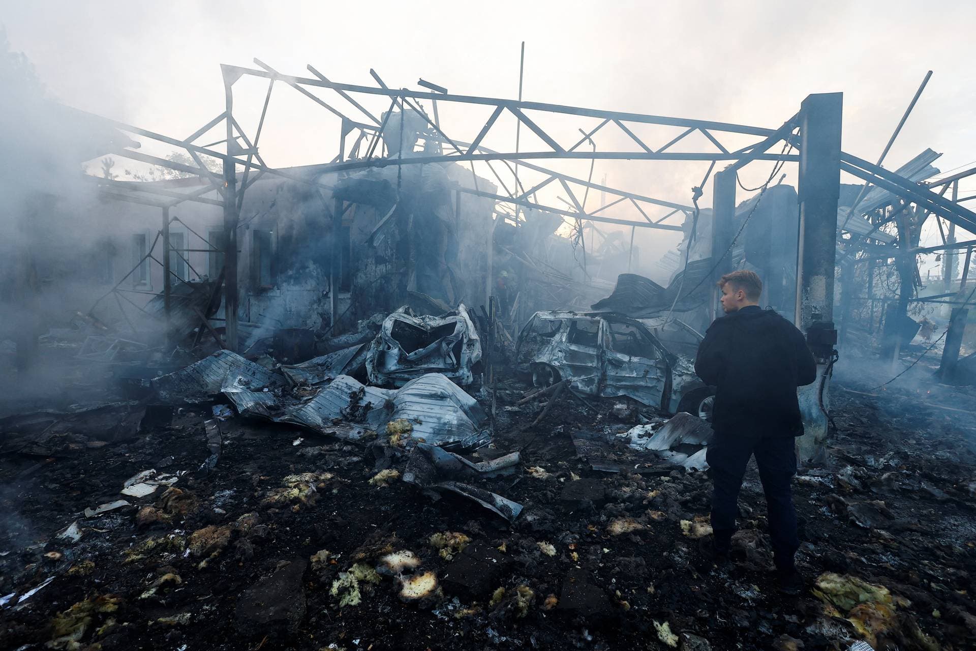 A worker inspects a site in a residential area damaged during a Russian missile strike in Kyiv
