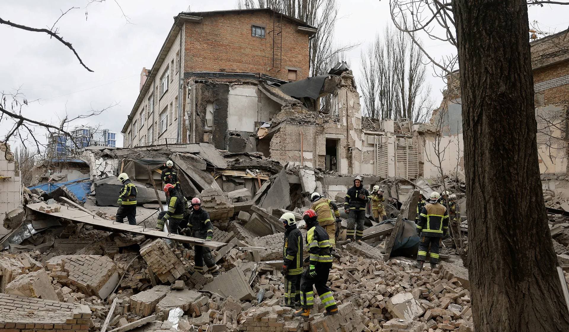 Rescuers work at the site of a building damaged by a Russian missile strike in Kyiv
