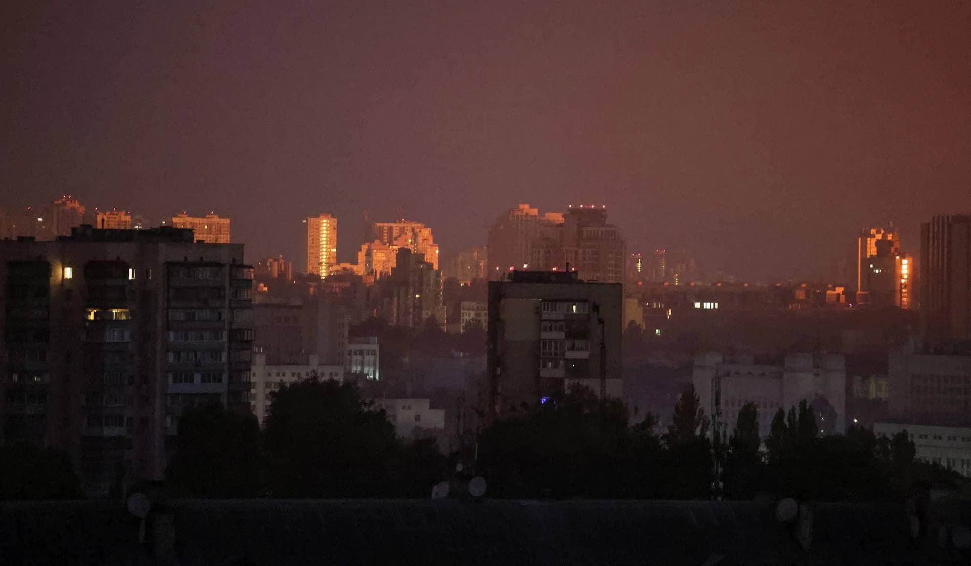 A flash from the explosion of a missile illuminates the city during a Russian missile strike in Kyiv