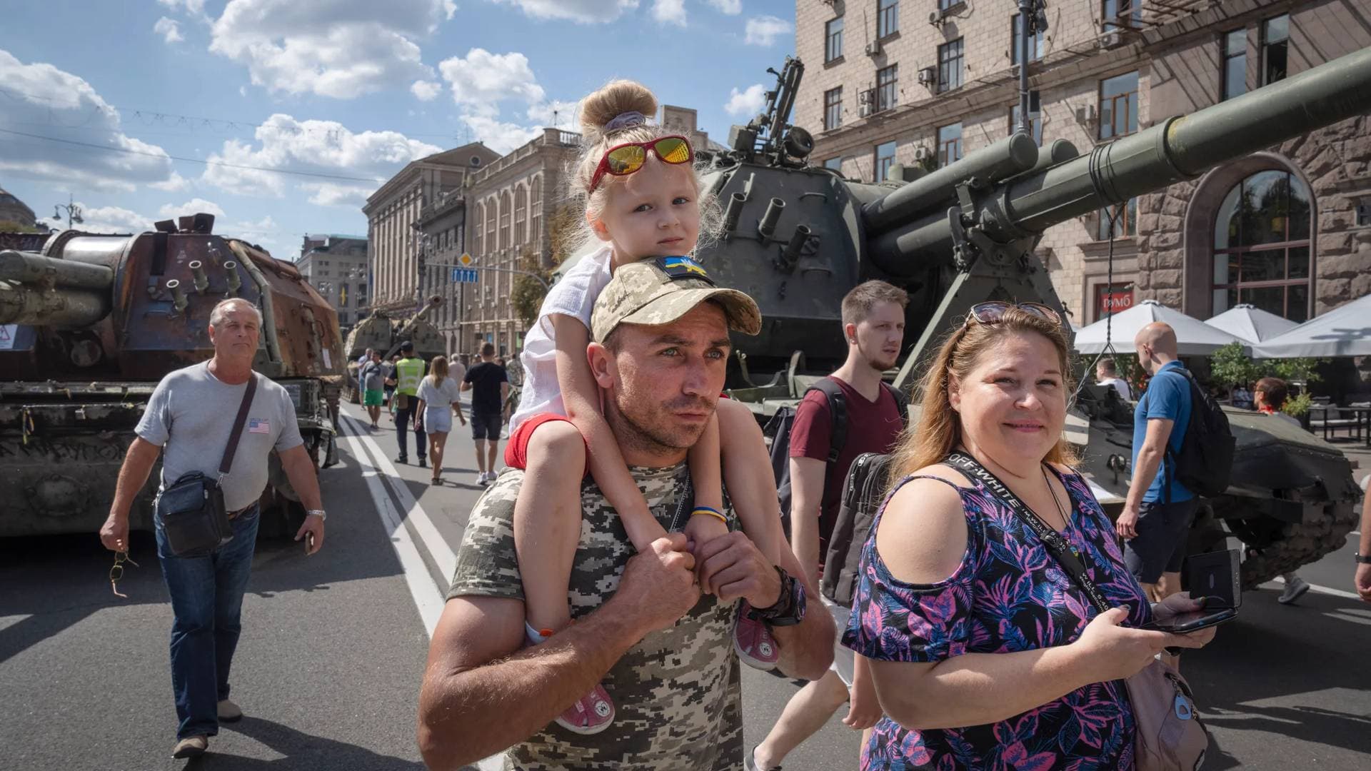 People look at a large column of burnt out and captured Russian tanks and infantry carriers on the central Khreshchatyk boulevard in Kyiv