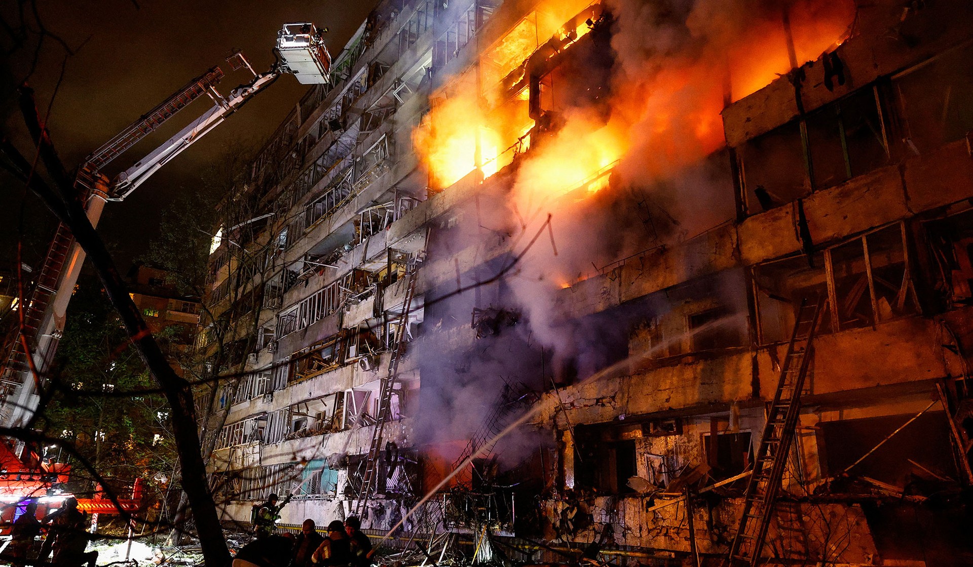 Firefighters work at the site of an apartment building damaged by a Russian missile strike in Kyiv