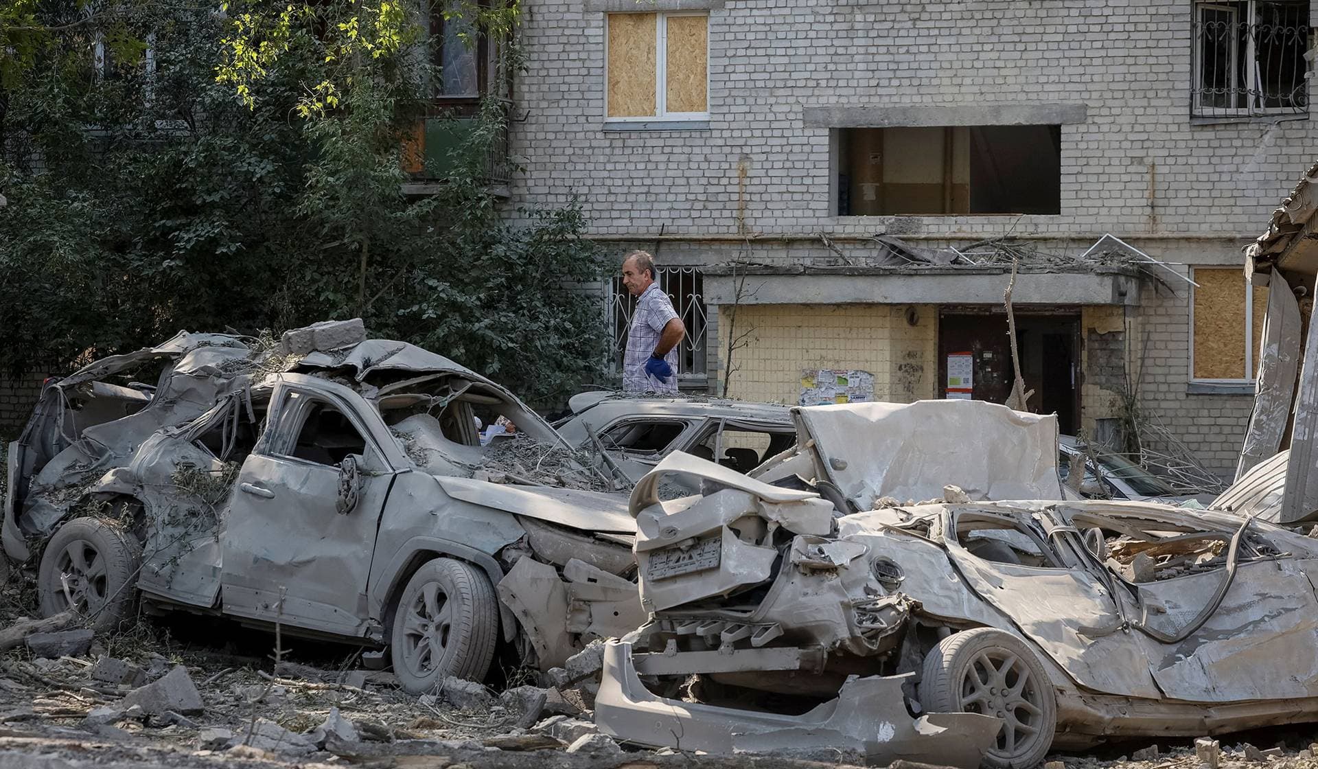 A man stands at a site of yesterday's missile strike in Kyiv