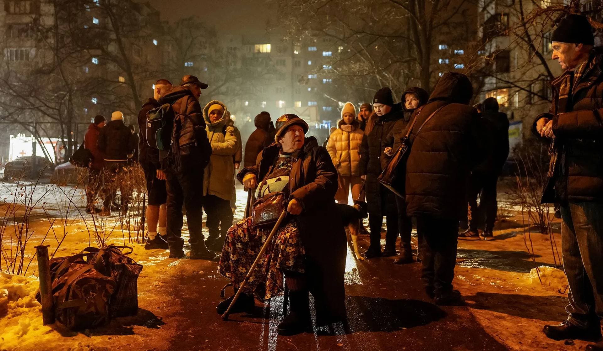 Local residents gather outside of their apartment building damaged during a Russian missile strike in Kyiv