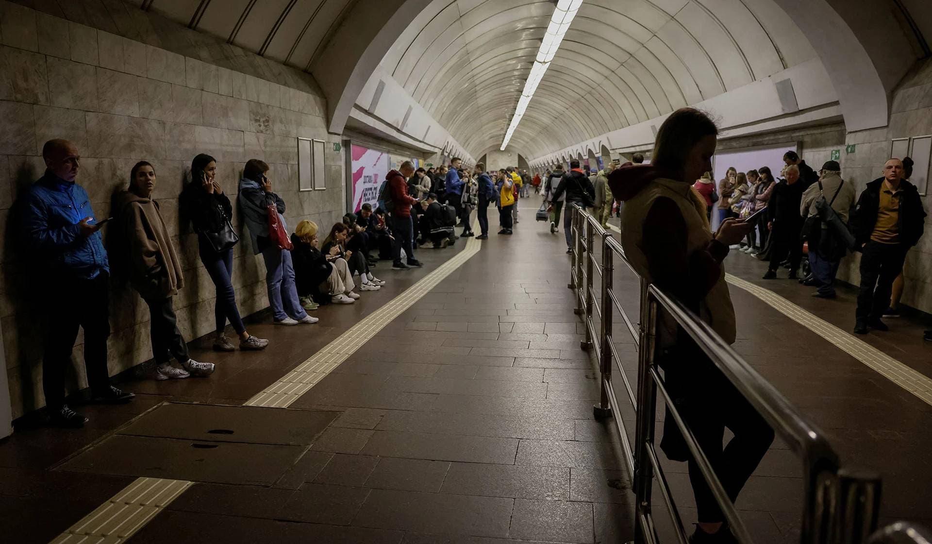 People shelter inside a subway station during an air raid alert in Kyiv