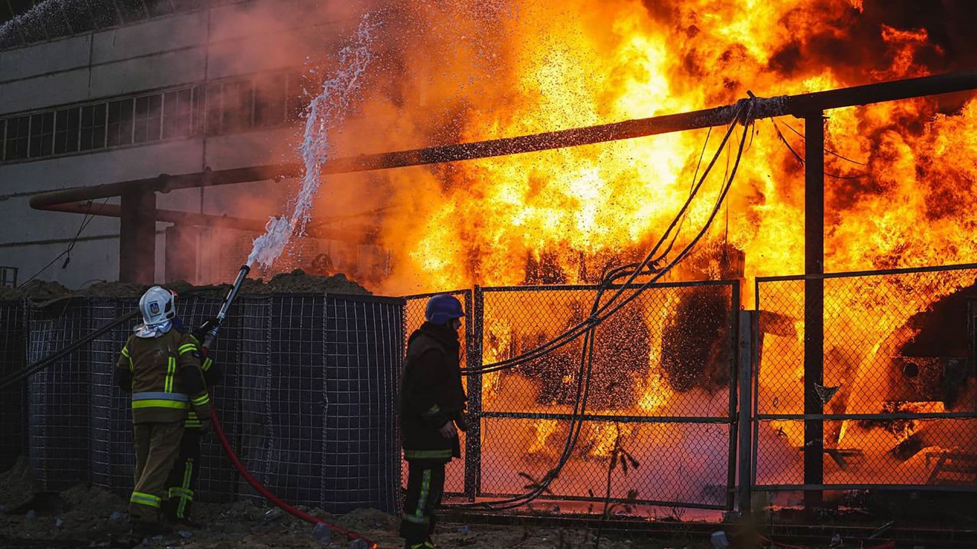 Firefighters work to put out a fire in a thermal power plant damaged by a Russian missile strike in Kyiv