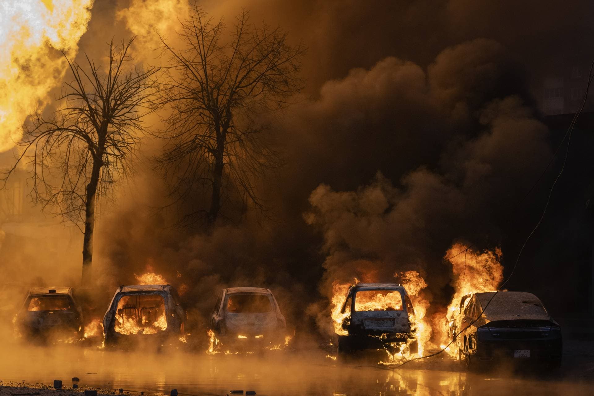 Cars burn after a Russian attack in Kyiv
