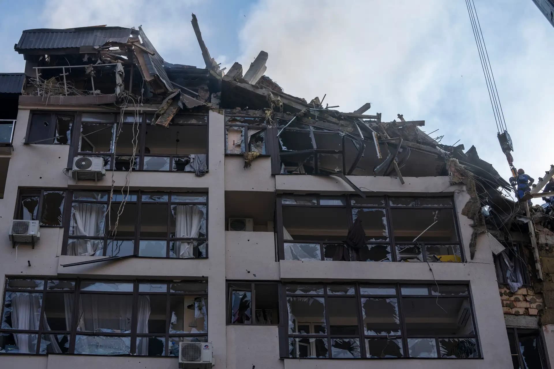 Firefighters work at the scene of a residential building following explosions, in Kyiv