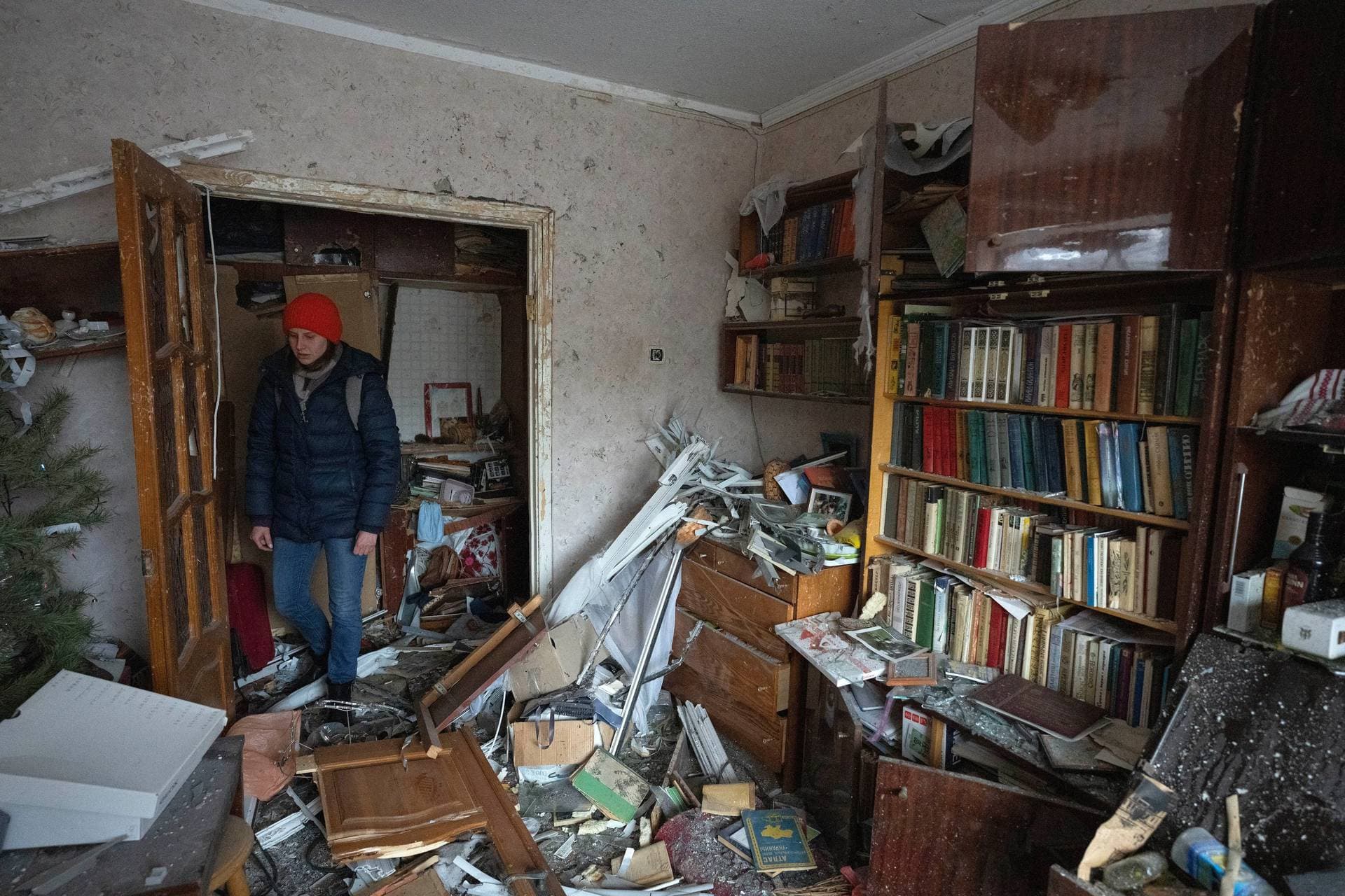 granddaughter looks at debris of her grandmother’s apartment in Kyiv