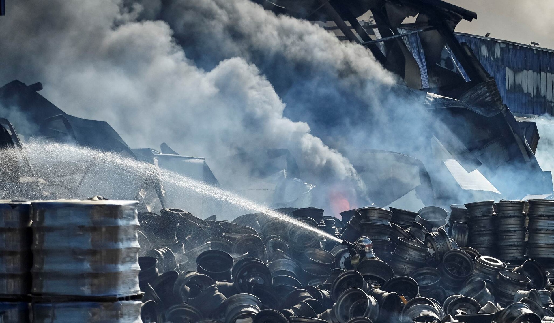 A firefighter works at the site of a Russian drone strike in Kyiv
