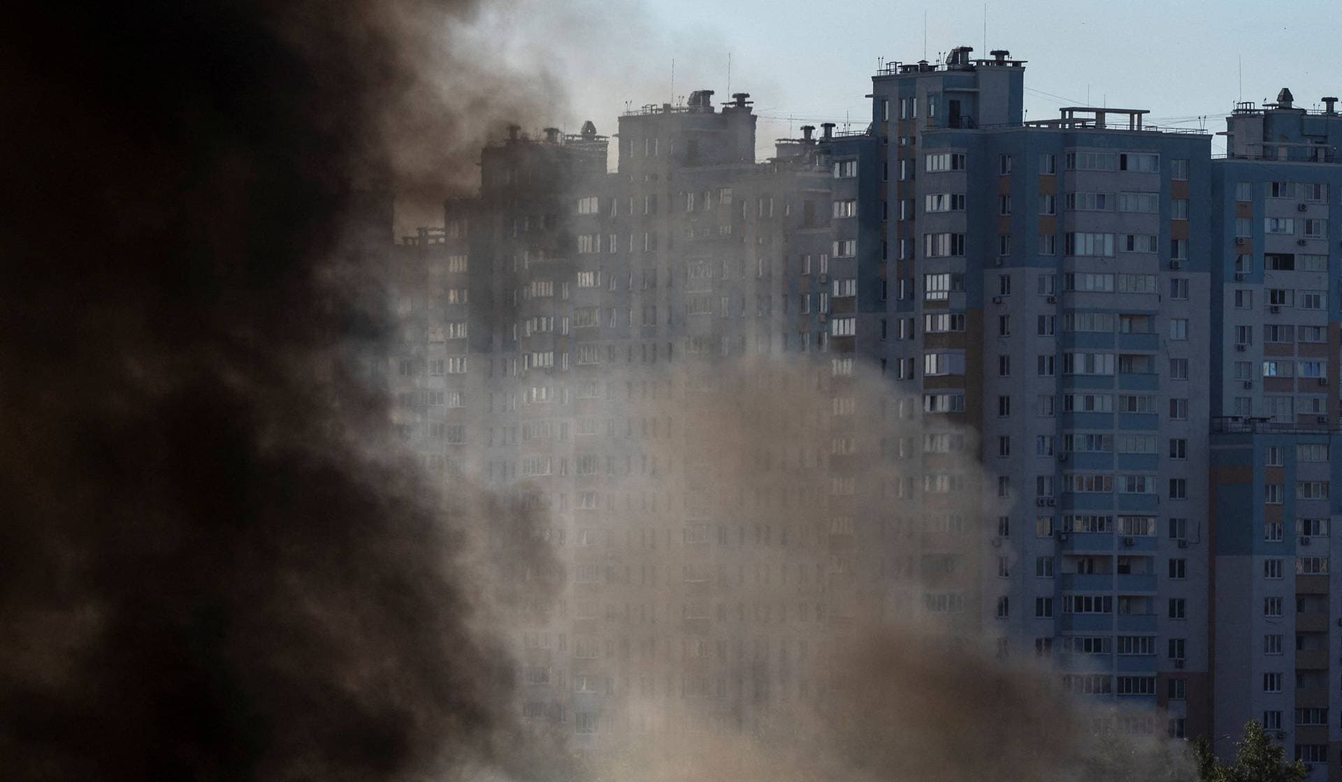 Smoke rises in a residential neighborhood after overnight Russian missile and drone attacks in Kyiv