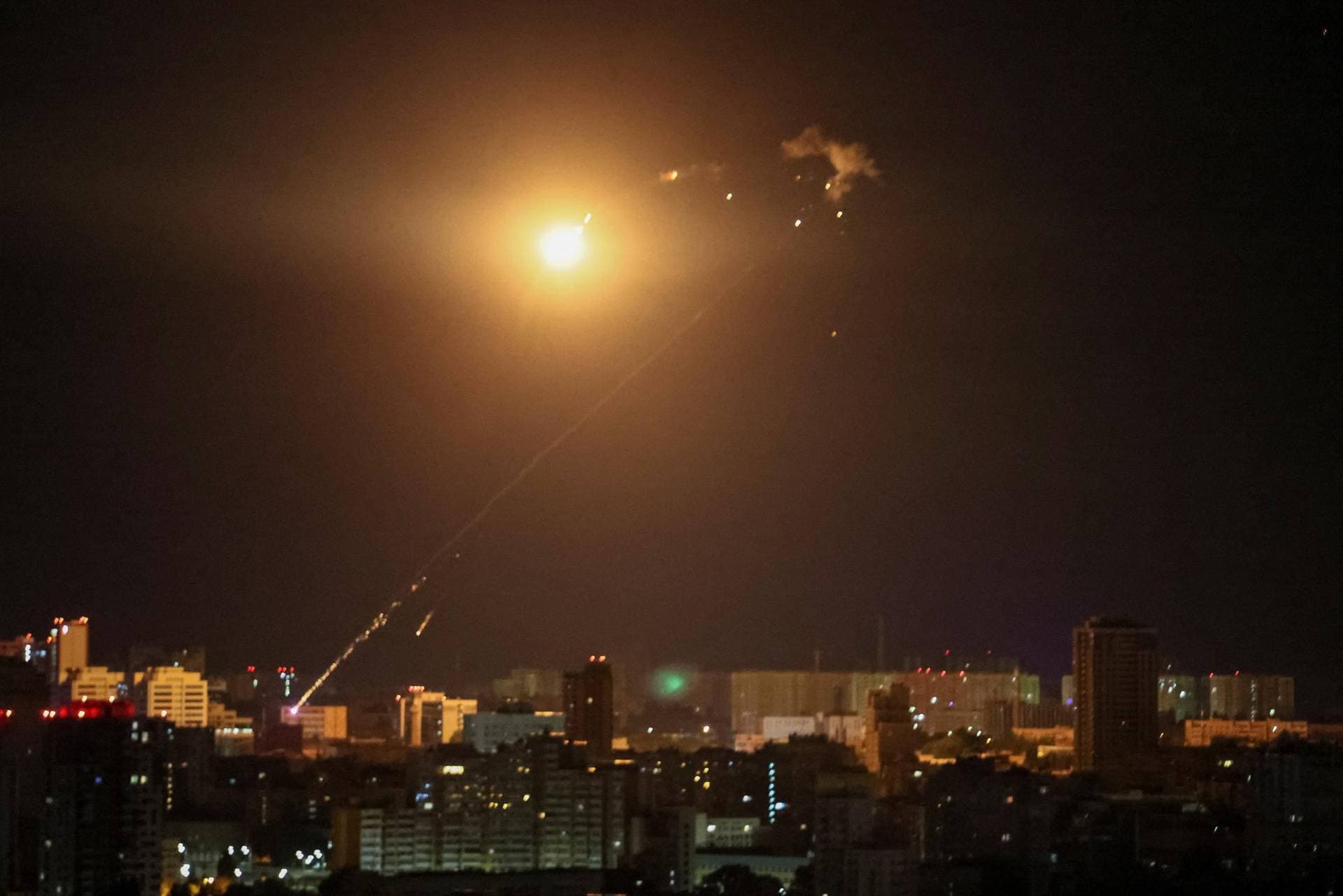 An explosion of a drone is seen in the sky over the city during a Russian drone strike in Kyiv