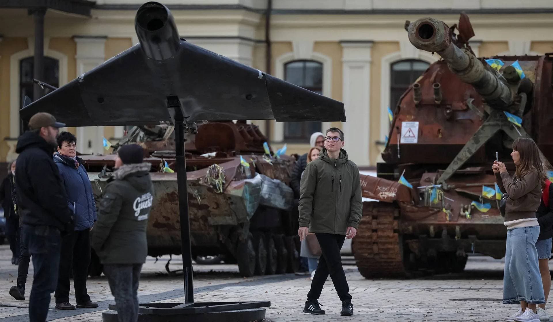 A teenager looks at a destroyed Russian combat drone at an exhibition displaying destroyed Russian military vehicles in central Kyiv
