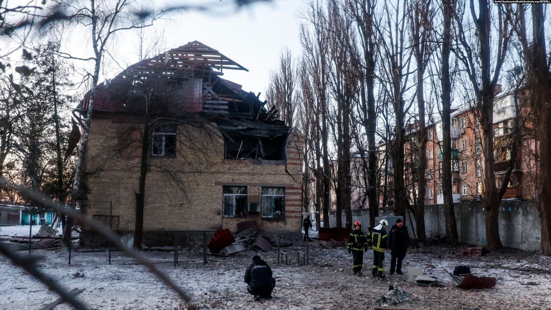 Rescue workers inspect the site of a drone attack in Kyiv