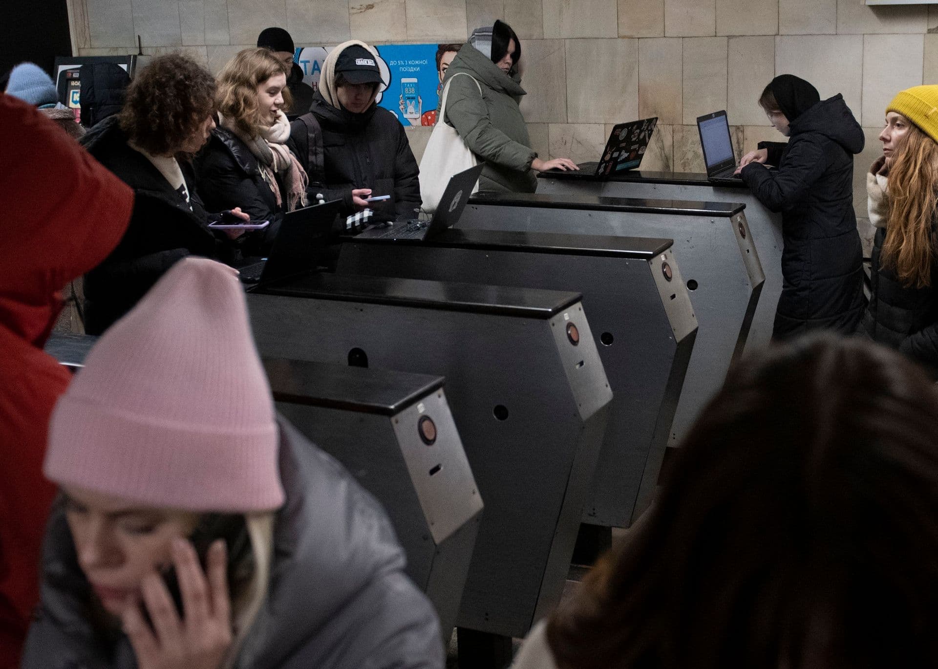 People work in the subway station being used as a bomb shelter during a rocket attack in Kyiv